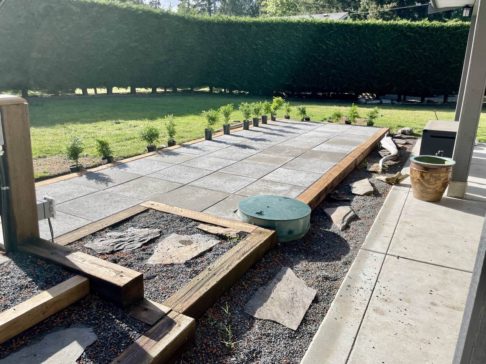 Large format concrete slabs being set on a compacted base with timber edging